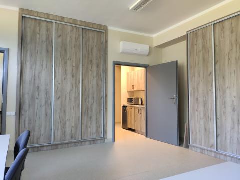 widok pokoju z dwoma szafami, przez drzwi widać aneks kuchenny