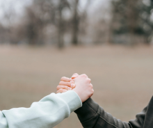 dłonie dwóch osób w geście wsparcia 